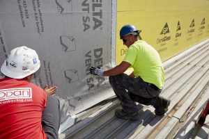 two installers applying delta vent sa air barrier