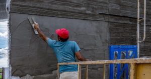 man applying stucco to wall